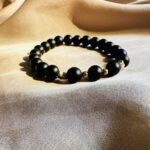Black onyx bracelet with gold spacers