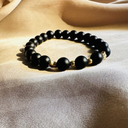Black onyx bracelet with gold spacers